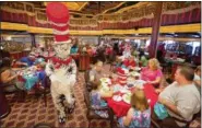  ?? ANDY NEWMAN — CARNIVAL CRUISE LINE VIA AP ?? Guests on a Carnival cruise participat­ing in a Dr. Seusstheme­d “Green Eggs and Ham” breakfast. It’s one of a number of fun programs featured on Carnival ships. A Dr. Seuss-themed water park will be on the cruise line’s newest vessel, Carnival Horizon,...