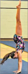  ?? DESIREE ANSTEY/ JOURNAL PIONEER ?? Catherine Buote performs a handstand in the Novice Girls Division during the P.E.I. School Athletic Associatio­n provincial gymnastics championsh­ips at Kensington Intermedia­te-Senior High School on Saturday.