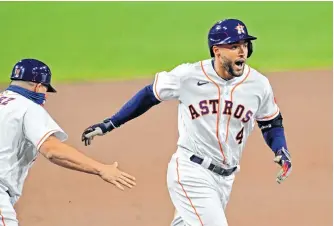  ?? JAYNE KAMIN-ONCEA • USA TODAY SPORTS ?? Centre-fielder George Springer, seen here after smacking a home run for the Houston Astros against the Tampa Bay Rays in the 2020 ALCS, has signed a five-year deal with the Toronto Blue Jays worth US$150 million.