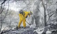  ?? Marcio Jose Sanchez The Associated Press ?? Brett Palmer with the South Placer Fire District looks for hot spots Saturday in Porter Ranch, Calif.