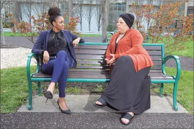  ?? Ned Gerard / Hearst Connecticu­t Media ?? Nichola Hall, left, and Emma Brooks, chair and vice chair of the Greater Bridgeport Ed Gomes Black Democratic Club, speak on a park bench in front of the Morton Government Center in Bridgeport on Wednesday.