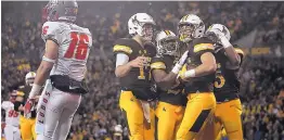  ?? JOSH GALEMORE/THE CASPER STAR-TRIBUNE VIA AP ?? Wyoming Cowboys celebrate a touchdown by Austin Fort (81) against New Mexico and safety Jacob Girgle (16).