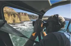  ?? Gabrielle Lurie / The Chronicle ?? Above: Eric Jones, founder of Sea Valor, uses binoculars during a helicopter flight to search for the body of Arunay Pruthi.