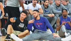  ?? RANDY BELICE / NBAE/GETTY IMAGES ?? Top: Dirk Nowitzki of the Dallas Mavericks high-fives a fan during the NBA Cares Special Olympics Basketball Clinic as part of the 2018 China Games on Thursday at the Oriental Sports Center in Shanghai. Above: Point guard Ben Simmons of the Philadelph­ia 76ers takes a selfie with a fan during the NBA Fan Appreciati­on Day on Thursday in Shanghai.