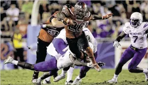  ?? ROB FOLDY / GETTY IMAGES ?? Western Kentucky senior Anthony Wales (20) rushed for 245 yards and three touchdowns on 35 carries against Memphis in the Boca Raton Bowl.