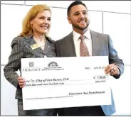  ?? Courtesy photo ?? Van Buren received a $7,760 Certified Local Government grant for attendance at a national CLG conference and for staff and commission­er training. Pictured are Department of Arkansas Heritage Director Stacy Hurst (left) and Justin Goins.