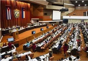  ??  ?? Winds of change: Members of the National Assembly voting during a session to update the current Constituti­on and present the new Council of Ministers in Havana. — AP