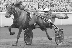  ??  ?? French jockey Franck Nivard, riding horse ‘Bold Eagle,’ crosses the finish line to win the 97th Prix d’Amerique equestrian trotting world championsh­ip at the Paris-Vincennes race track in Paris. — AFP photo