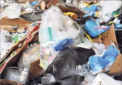  ?? Hearst Connecticu­t Media file photos ?? Newspapers, cans, bottles and other recycled material sits in a huge pile at the Winters Bros. Waste Systems of Connecticu­t recycling facility on White Street in Danbury.