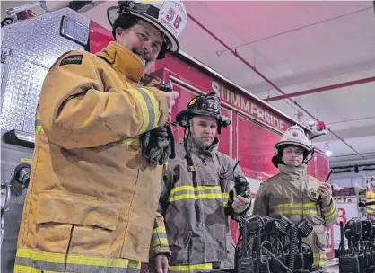  ?? ALISON JENKINS/JOURNAL PIONEER ?? Summerside Fire Chief Ron Enman, left, tests out the new radio equipment the department acquired with safety officer Wally MacAusland and deputy chief Clay Moase.