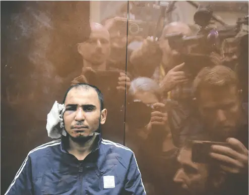  ?? OLGA MALTSEVA / AFP VIA GETTY IMAGES ?? Saidakrami Murodalii Rachabaliz­oda, suspected of taking part in the attack of a concert hall that killed 137 people,
sits inside the defendant box as he waits for his pretrial detention hearing in a Moscow court on Sunday.