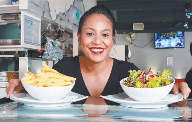  ??  ?? OFF THE MENU: Frydays manager Charley Eparaima displays chips and a salad, but the fish and chippery can’t offer sweet potatoes. Picture: JUSTIN BRIERTY