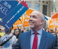  ?? GERRY KAHRMANN ?? A new poll suggests voters believe NDP Leader John Horgan, seen walking past NDP and Liberal supporters as he arrived for Wednesday’s televised leaders debate, had the night’s best performanc­e.