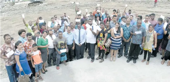  ?? Photo: Vilimoni Vaganalau ?? Minister for Local Government, Housing, Environmen­t, Infrastruc­ture and Transport Parveen Bala with offer letter recipients at Tacirua subdivisio­n on November 16, 2017.