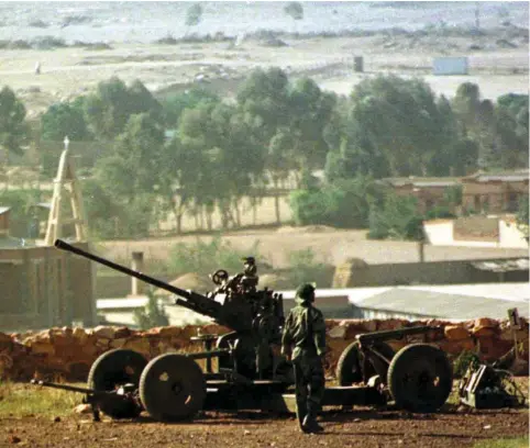  ??  ?? ERITREAN TROOPS stand guard at a position in the 1990s. Many people have fled the country since then.