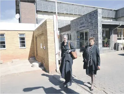  ?? Picture :Nigel Sibanda ?? CHARGED UP. Stefanie Fick, left, and Dominique Msibi of Organisati­on Undoing Tax Abuse leave Brixton Police Station yesterday.