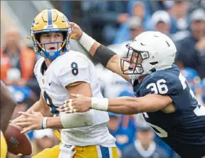  ?? Steph Chambers/Post-Gazette ?? Penn State’s Jan Johnson pressures Pitt quarterbac­k Kenny Picket. PIckett set a career high with 372 yards passing in the Panthers loss.