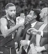  ?? AP/FRANK FRANKLIN II ?? South Carolina guard Sindarius Thornwell is greeted by coaches as he comes off the floor late in the second half of a 70-50 victory over Baylor in the East Regional in Madison Square Garden in New York.