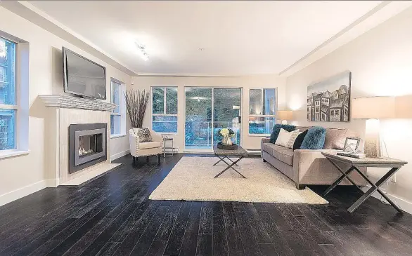  ??  ?? This home at 208-1283 Parkgate Ave. in North Vancouver sold for $1,070,000. Dark laminate floors contrast with a neutral colour palette for a crisp, clean look.