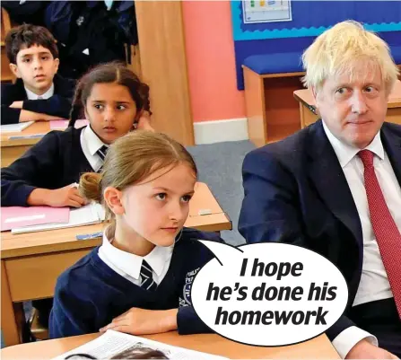  ??  ?? Back to school: Boris Johnson told pupils the Government was ‘working very hard to get a deal’ during a visit to Pimlico primary in central London yesterday