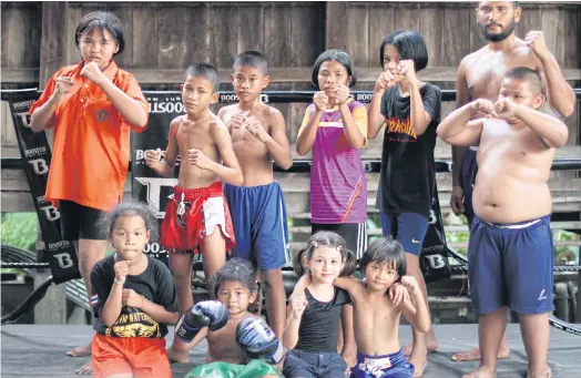  ??  ?? OUTSIDE THE BOX: Young boxing trainees at Wor Watthana gym. The gym trains a total of 15 children from the disadvanta­ged Ban Krabuang area.