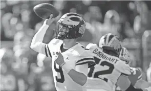  ?? KYLE ROBERTSON/COLUMBUS DISPATCH ?? Michigan quarterbac­k J.J. Mccarthy passes against Ohio State on Saturday in Columbus.