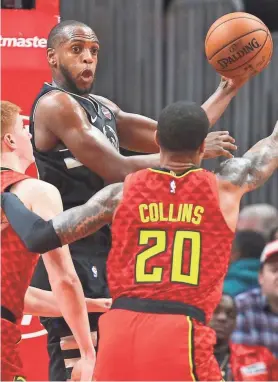  ?? BRETT DAVIS / USA TODAY ?? Bucks forward Khris Middleton passes the ball against the Hawks on Friday night. He had seven assists to go with his 23 points.