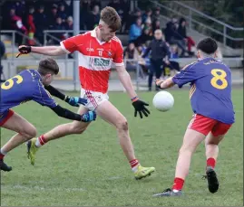  ??  ?? Andrew Smith and Cian Hughes of Ballynastr­agh Gaels (winners) attempt to block the kick of Fethard’s Eoin Whelan in the 2019 Gorey Guardian Under-15 football Division 1 championsh­ip final.