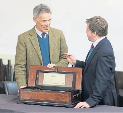  ?? Picture: Andrew Smith. ?? Above: Charles Graham-campbell, left, and senior valuer Hamish Wilson at Culloden Battlefiel­d Visitor Centre with a Baker Troll music box from circa 1900.
Below: Bonhams has auctioned James Mcintosh Patrick paintings over the years.