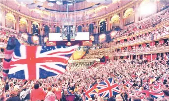  ?? — AFP photo ?? File photo shows taken on Sept 7, 2013 people wave flags at the Royal Albert Hall in west London on the Last Night of the Proms.