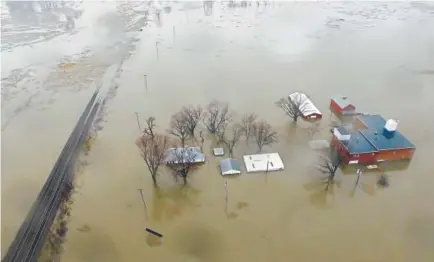  ?? DroneBase, via The Associated Press ?? The Missouri River floods in Pacific Junction, Iowa. The Army Corps of Engineers says rivers breached at least a dozen levees in Nebraska, Iowa and Missouri in the past few days.