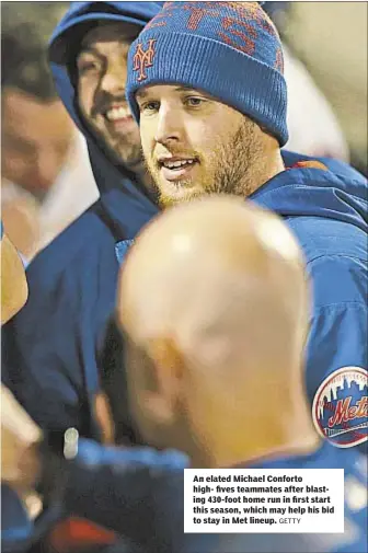  ?? GETTY ?? An elated Michael Conforto high- fives teammates after blasting 430-foot home run in first start this season, which may help his bid to stay in Met lineup.