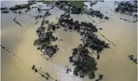  ??  ?? Houses and fields partially submerged by floodwater­s