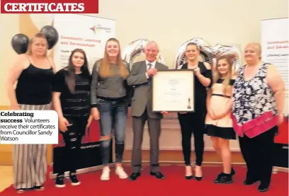  ??  ?? Celebratin­g success Volunteers receive their certificat­es from Councillor Sandy Watson