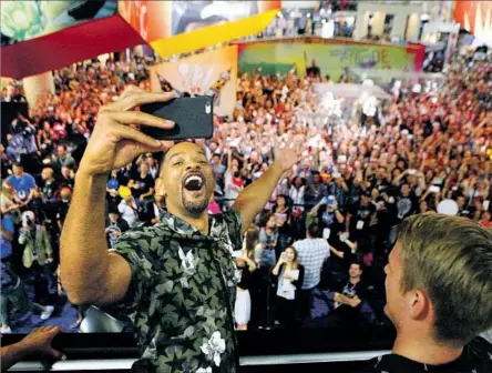  ?? Photograph­s by Harrison Hill Los Angeles Times ?? WILL SMITH takes a video of the crowd — as the moment is captured on phones — during a “Suicide Squad” signing at Comic-Con.