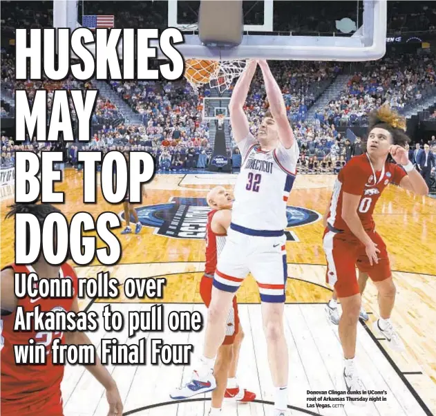  ?? GETTY ?? Donovan Clingan dunks in UConn’s rout of Arkansas Thursday night in Las Vegas.