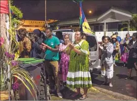  ?? Photog r aphs by Mathurin Derel Associated Press ?? NEW CALEDONIAN­S celebrate the results of an independen­ce referendum on Sunday. Officials said 53.3% of voters supported keeping ties with France.