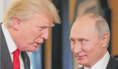  ?? MIKHAIL KLIMENTYEV/AFP/GETTY IMAGES ?? President Donald Trump and Russian President Vladimir Putin last year.