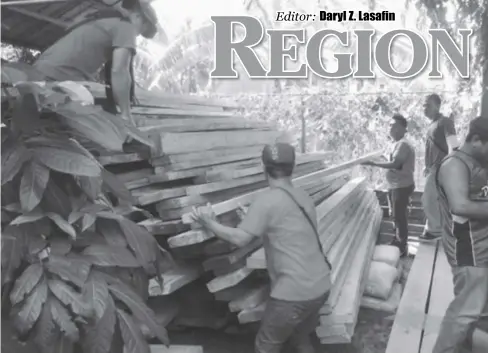  ?? DENR REGION 6 ?? Former rebels in Aklan province stack illegally transporte­d timber that Environmen­t department enforcers have apprehende­d, in this photo the agency released in October 2016. Some P1,401,956.54 worth of illegally transporte­d forest products were...