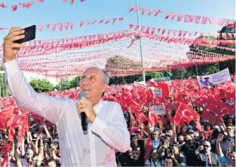  ??  ?? Muharrem Ince takes a selfie at a rally in Gaziantep, eastern Turkey, on Monday. Mr Ince is seen as a strong contender to end the reign of President Recep Tayyip Erdogan, below