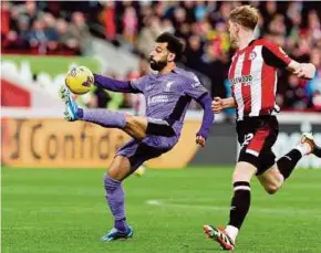 ?? AFP PIC ?? Liverpool’s Mohamed Salah controllin­g the ball during Saturday’s Premier League match against Brentford in London.