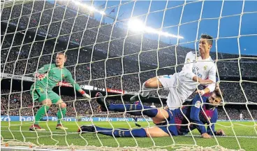  ?? /Reuters ?? Him again: Real Madrid’s Cristiano Ronaldo scores the first goal against Barcelona on Sunday, but the striker was injured in the process and is fighting to be fit for the Champions League final against Liverpool on May 26.