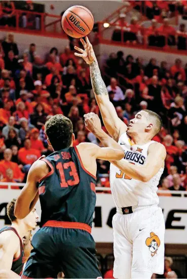  ?? [PHOTO BY NATE BILLINGS, THE OKLAHOMAN] ?? Oklahoma State’s Jeffrey Carroll, right, puts up a shot over Stanford’s Oscar da Silva during Monday night’s second round NIT game at Gallagher-Iba Arena in Stillwater.