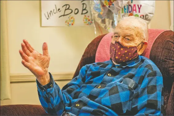  ?? (Lancaster LNP/Ty Lohr) ?? Bob Adams, who turned 100 years old Feb. 15, recalls his life, from the Air Force to photograph­ing historical figures, in his apartment at the Quarryvill­e, Pa., Presbyteri­an Retirement Community. Adams tried to enlist as an aviation cadet, where he passed the first day’s written exams, but failed the second day’s physical because of his flat feet. Determined to fly, Adams eschewed serving on land and on the seas and enlisted in the Army Air Forces.