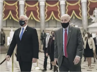  ?? J. SCOTT APPLEWHITE/AP ?? Senate Sergeant-at-Arms Mike Stenger (right) escorts Vice President Mike Pence to the House chamber at the Capitol after midnight on Jan. 7, 2021, as lawmakers returned to complete the certificat­ion of electors in the 2020 presidenti­al election.