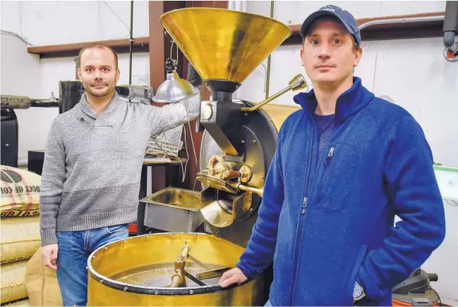  ?? ROBERTO E. ROSALES/JOURNAL ?? Juan Certain, left, and his brother David, came to the United States from Colombia in 1999 as political refugees. Today they’ve started a coffee business, using beans from their grandfathe­r’s farm in Colombia. Here they stand next to one of their roasters.