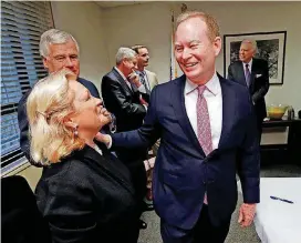  ?? [PHOTOS BY STEVE SISNEY, THE OKLAHOMAN] ?? Mayor Mick Cornett speaks with Ward 6 Councilwom­an Meg Salyer at a reception for Cornett before Tuesday’s city council meeting. Cornett presided over his last regular council meeting after 14 years and a record four terms as mayor.