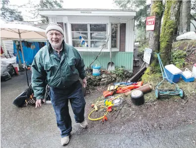  ?? DARREN STONE, TIMES COLONIST ?? Lothar Netzel holds a garage sale outside his mobile home at Thetis Lake Campground and Trailer Park. The park’s mobilehome residents are facing eviction to make way for a proposed housing project. “We don’t want to leave,” Netzel says. “It’s basically cheap living, close to a park and we’re comfortabl­e here.”
