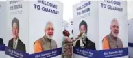  ?? - Reuters ?? GEARING UP: A worker cleans a hoarding featuring India’s Prime Minister Narendra Modi and his Japanese counterpar­t Shinzo Abe ahead of Abe’s visit, in Ahmedabad, India, on Tuesday.