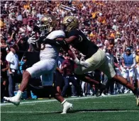  ?? RON CHENOY/USA TODAY SPORTS ?? Minnesota running back Trey Potts, left, scores a touchdown past Colorado cornerback Christian Gonzalez in the third quarter on Saturday at Folsom Field in Boulder, Colo. Potts rushed for three touchdowns.